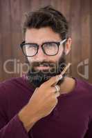 Hipster man doing his beard