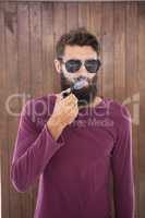 Hipster man smoking the pipe