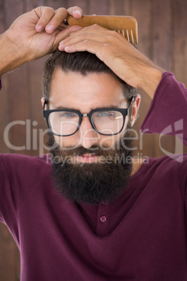 Hipster man using a comb