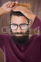 Hipster man using a comb