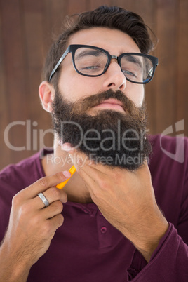 Hipster man using a razor