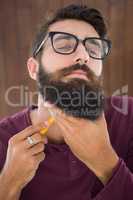 Hipster man using a razor