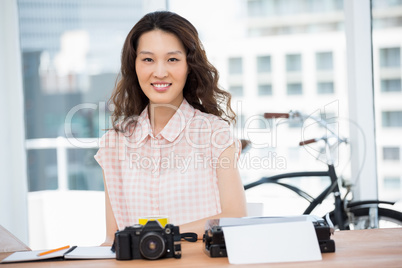 Hipster woman posing for the camera while sitting