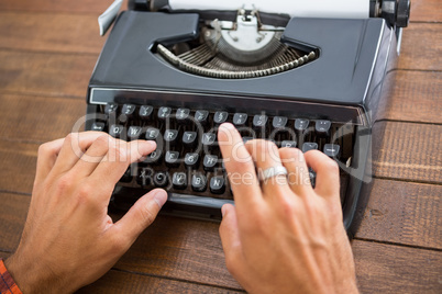 Hipster man using a typewriter