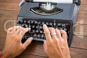 Hipster man using a typewriter