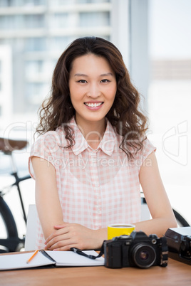 Hipster woman posing for the camera while sitting