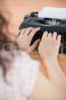 Hipster woman using a typewriter
