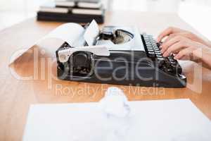 Hipster woman using a typewriter