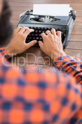 Hipster man using a typewriter