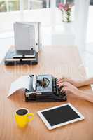 Hipster woman using a typewriter