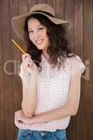 Hipster woman holding a pen