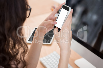 A woman is using her smartphone