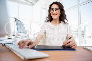 A woman is typing on computer