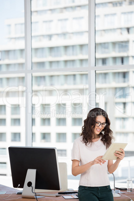 a businesswoman is using her pad in her office