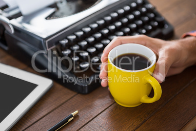 A man is drinking a coffee