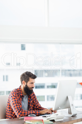 An hipster man is working on his computer