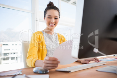 A businesswoman is working at her desk