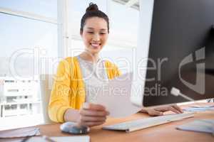 A businesswoman is working at her desk