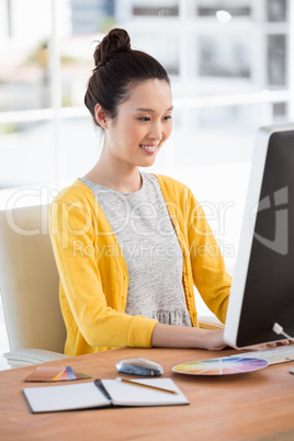A woman is working on her computer