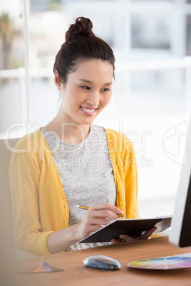 A woman is looking at her computer