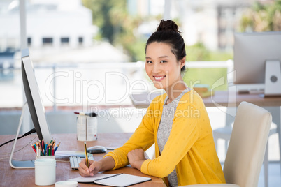 A woman is working at her desk