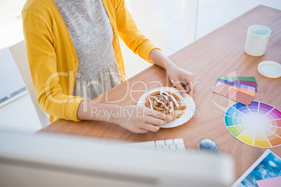 Woman eating breakfast at work