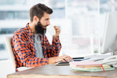 Handsome hipster working on his computer