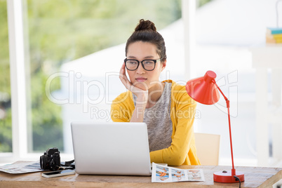 Hipster sitting in front of a laptop