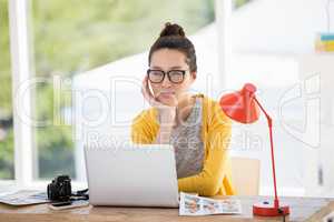 Hipster sitting in front of a laptop