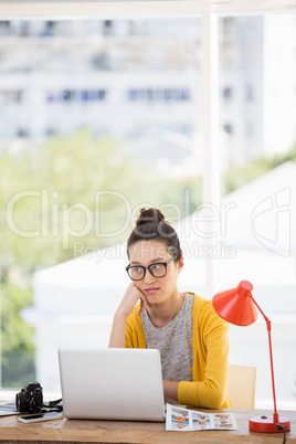 Hipster sitting in front of a laptop