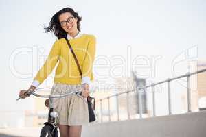 Hipster walking her bike