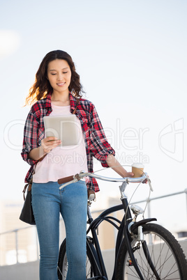 Hipster walking her bike