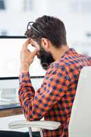 Hipster sitting in front of a computer