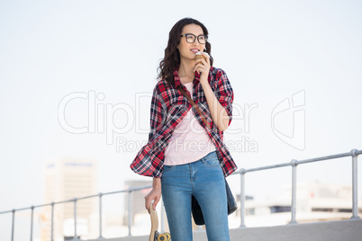 Hipster with skateboard and coffee