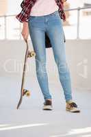 Hipster holding a skateboard
