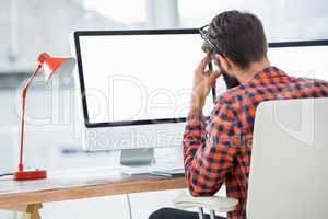Hipster sitting in front of a computer