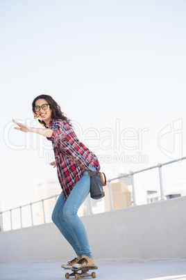 Hipster driving with skateboard