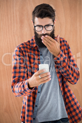 Shocked hipster with smartphone