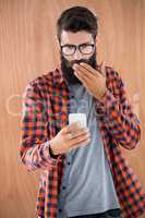 Shocked hipster with smartphone