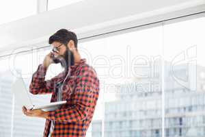 Hipster using phone and laptop