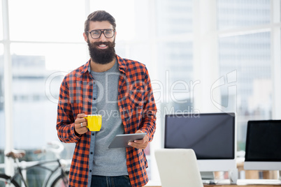 Hipster using tablet and drinking coffee