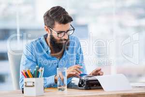 Hipster using type writer