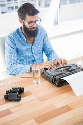 Hipster using type writer