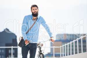 Hipster walking his bike