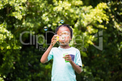 A little boy blowing bubbles