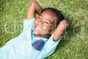 Smiling boy lying on grass
