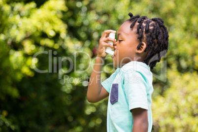 Boy using an asthma inhaler