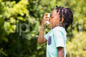 Boy using an asthma inhaler