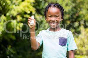 Boy showing his asthma inhaler