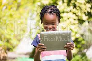 A little Boy is using a tablet